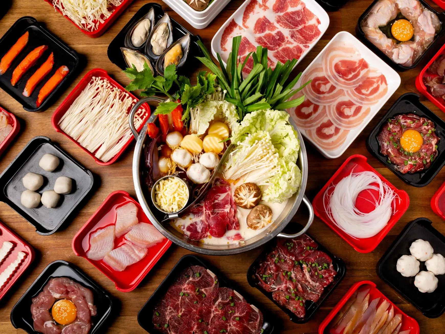 Variety Hot Pot Ingredients - A diverse selection of meats, seafood, veggies, and mushrooms for hot pot at T-Pot & BBQ, a Asian Fusion Restaurant in College Park