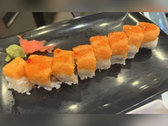 T-Pot&BBQ-Asian-Fusion-Restaurant-Salmon-Roll-College-Park Delicious sushi roll with salmon and rice, served with wasabi and pickled ginger.