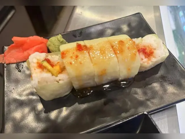 T-Pot&BBQ-Asian-Fusion-Restaurant-Special-Sushi-Roll-College-Park Unique sushi roll with various fillings and rice, topped with sauce, served with wasabi and pickled ginger.